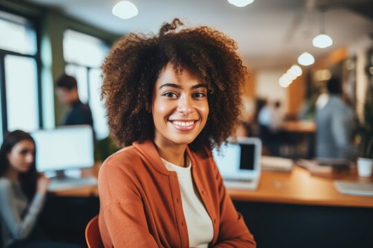 Smiling portrait of a happy young african american woman working for a modern startup company in a business ofice