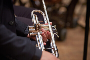 Fototapeta premium Close-up of a musician's hands playing the trumpet