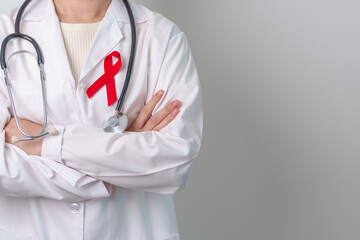 Doctor with Red Ribbon for December World Aids Day, acquired immune deficiency syndrome, multiple...