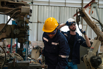 Team of technician worker checking and repair pressing metal machine at factory, Machine maintenance technician operation concept.