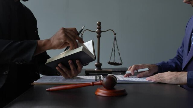 Attorney reading law code, studying the constitution to protect human rights closeup, Male lawyer or judge working with Law books, gavel	
