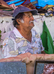 Elderly latino man posing for a photograph
