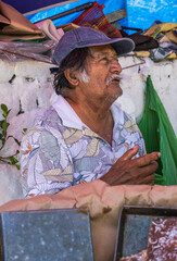 Elderly latino man posing for a photograph and speaking