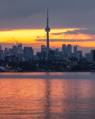 Dramatic golden light at sunrise behind the Toronto skyline 

