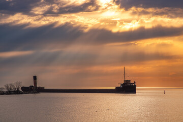 Vibrant sunrise with sun rays over a long freighter ship pier. Port Credit Mississauga, Lake Ontario - obrazy, fototapety, plakaty