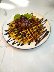 Waffle food with ice cream on top, usually this dish appears at the end of an event.