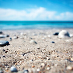 Fototapeta na wymiar Empty sandy beach with pebbles and blurred tropical beach background. Focus on the foreground. Shallow depth of field. High quality photo