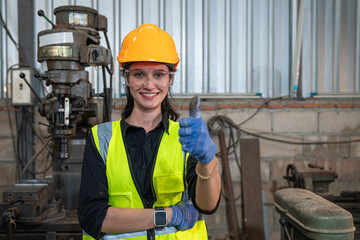 Portrait of female automation engineer standing and looking camera in industrial factory.