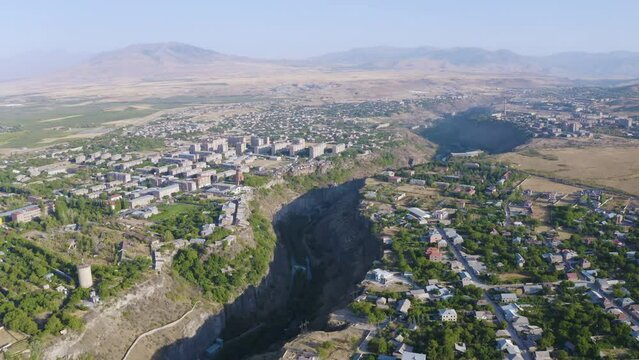 Backward reveal drone footage of Hrazdan canyon, Arzni and Nor Geghi villages on sunny summer day. Kotayk Province, Armenia.