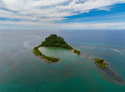 Beautiful landscape of Cabugao Island and blue sea. Blue skies and clouds. Mindanao, Philippines.