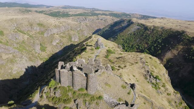 Orbital aerial shot of Amberd fortress on sunny summer day. Aragatsotn Province, Armenia.