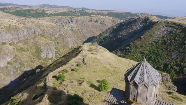 Backward reveal drone footage of Vahramashen Church on sunny summer day. Amberd fortress, Aragatsotn Province, Armenia.