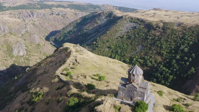 Forward reveal aerial shot of Vahramashen Church and Amberd gorge on sunny summer day. Amberd fortress, Aragatsotn Province, Armenia.