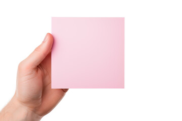 Obraz premium A human hand holding a blank sheet of pink paper or card isolated on a white background