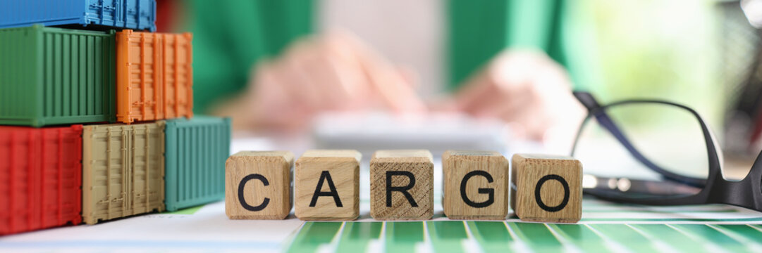 Heap of various shipping containers and word cargo collected from wooden cubes in financial report. - Powered by Adobe