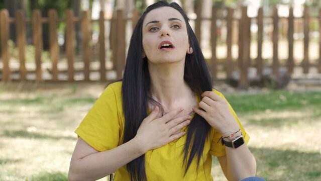 The woman is having a heart attack.