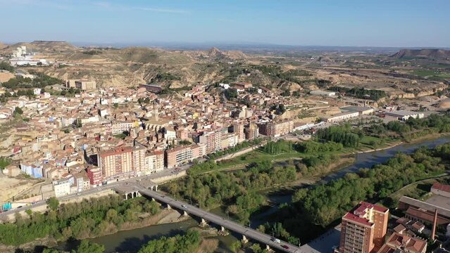 Scenic spring aerial view of El casco or Fraga la Vieja, old historic district of Spanish town of Fraga located on hilly Cinca river valley on sunny day. High quality 4k footage