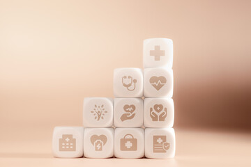 White dice with health icons on the front, stacked in layers on a wooden floor against a bright orange background