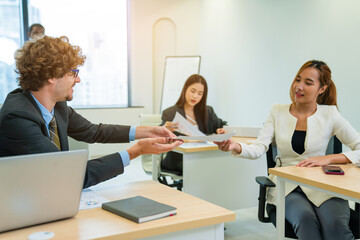 Leader or businessman sends documents male colleague in the creative office.