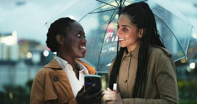 Women, friends and smartphone, umbrella and city with travel, insurance with ride share app while outdoor. Commute, journey and using phone to call taxi, security in winter weather in urban street