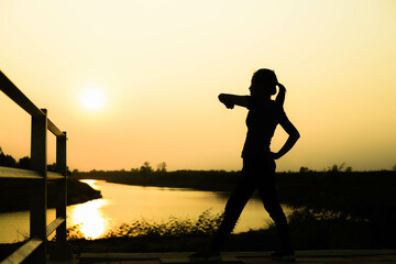 Fototapeta premium Silhouette of woman praying over beautiful sky background 
