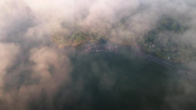 Aerial view over low clouds, overlooking traditional fish cages of Bali, Indonesia