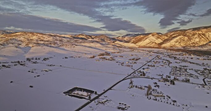 Oakley Utah Aerial v2 panoramic panning view drone flyover town area capturing pristine snow fields and beautiful golden sunset shinning on the mountain ranges - Shot with Mavic 3 Cine - February 2023