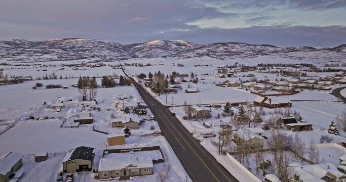 Oakley Utah Aerial v5 cinematic drone flyover town area along the road capturing pristine snow landscape of winter wonderland and beautiful mountainscape views - Shot with Mavic 3 Cine - February 2023