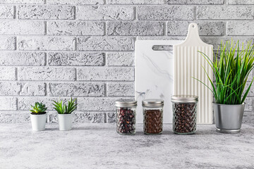 A set of beautiful compact glass jars for storage on the kitchen countertop in a stylish kitchen interior. front view. minimalism.