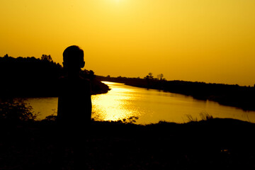 Silhouette of a family comprising a father, mother and two children happy family the sunset.Concept of friendly  - 646230027