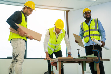 Team Architector with draft plan of building and laptop talking on constructing site. Construction manager and engineer working on building site in the office, teamwork.	