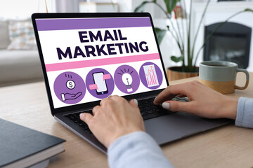 Email marketing. Woman using laptop at table, closeup