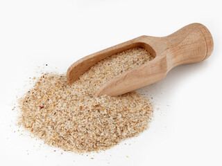 heap of psyllium husk in wooden scoop isolated on white background, Plantago Indica seed pods for use as fiber for the keto diet