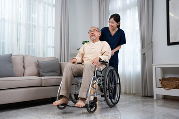 A young positive and happy Asian female nurse or physical therapist in a blue uniform, smiling...