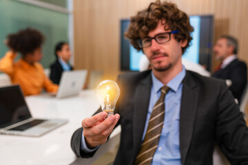 Businessman holding bright lights bulb. idea concept with innovation and inspiration.	