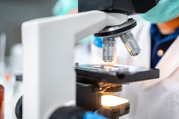 professional chemist woman laboratory using scientific microscope for science research, chemistry scientist with microbiology medicals equipment technology to working with medicine biology experiment