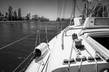 Between sea and lagoon. Sailing trip between the Marano lagoon and the Gulf of Trieste. Black and white.