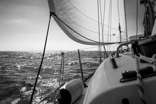 Between sea and lagoon. Sailing trip between the Marano lagoon and the Gulf of Trieste. Black and white.