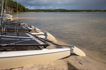 Carcans Medoc water beach lake with boats on sand in summer day