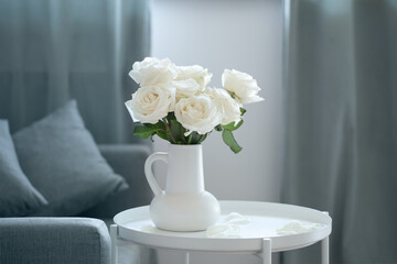 bouquet of white roses in white jug in modern interior