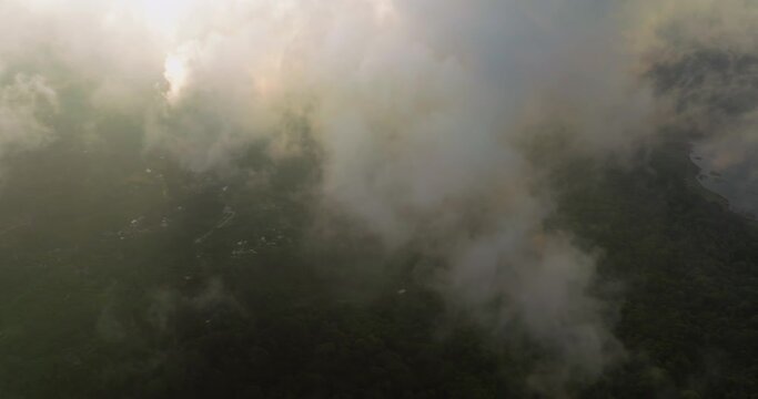 Mystic and foggy drone flight over tropical rainforest. Agung volcano slope