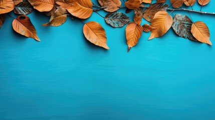 Autumn leaves on blue background with copy space. Fall concept.