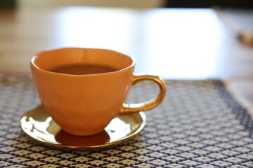 Cup of hot drink on table indoors, closeup. Space for text