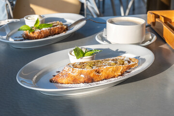 Strudel with apples, nuts and raisins. A scoop of vanilla ice cream.