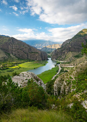 Beautiful landscape with mountains, valley and a river on a sunny summer day with clouds. Dagestan