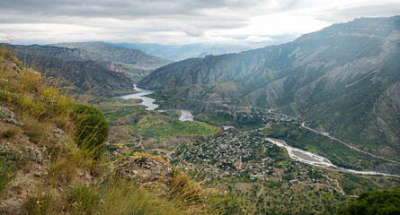 Beautiful landscape with mountains, valley and a river on a sunny summer day with clouds. Dagestan