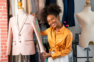 Portrait of young woman fashion designer stylish working in dressmaker studio or workshop, Fashion design concept. 