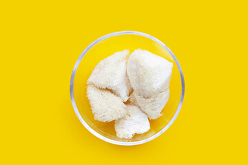 Fresh lion's mane mushroom on yellow background. (Yamabushitake Mushroom)