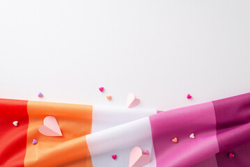 Overhead image of the Lesbian Pride flag, adorned with petite hearts, all against a white background for text or ads