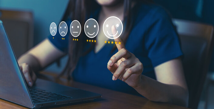 Customer review good rating concept people use computer laptop and pressing five star rating on visual screen for the positive customer feedback testimonial, five star icon on visual screen.	